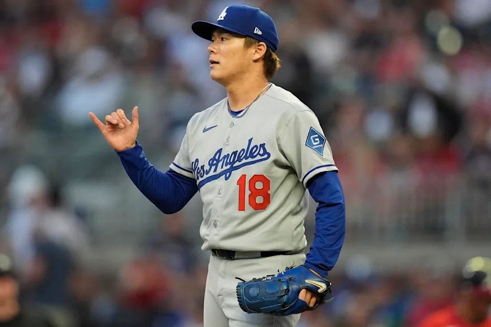 Dodgers pitcher Yoshinobu Yamamoto reacts in the fourth inning against the Braves on Friday.
