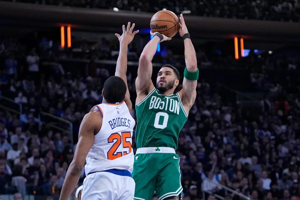 Boston Celtics' Jayson Tatum, right, shoots over New York Knicks' Mikal Bridges, left, during the second half of Game 3 of an NBA basketball second-round playoff series, Saturday, May 10, 2025, in New York. (AP Photo/Pamela Smith)