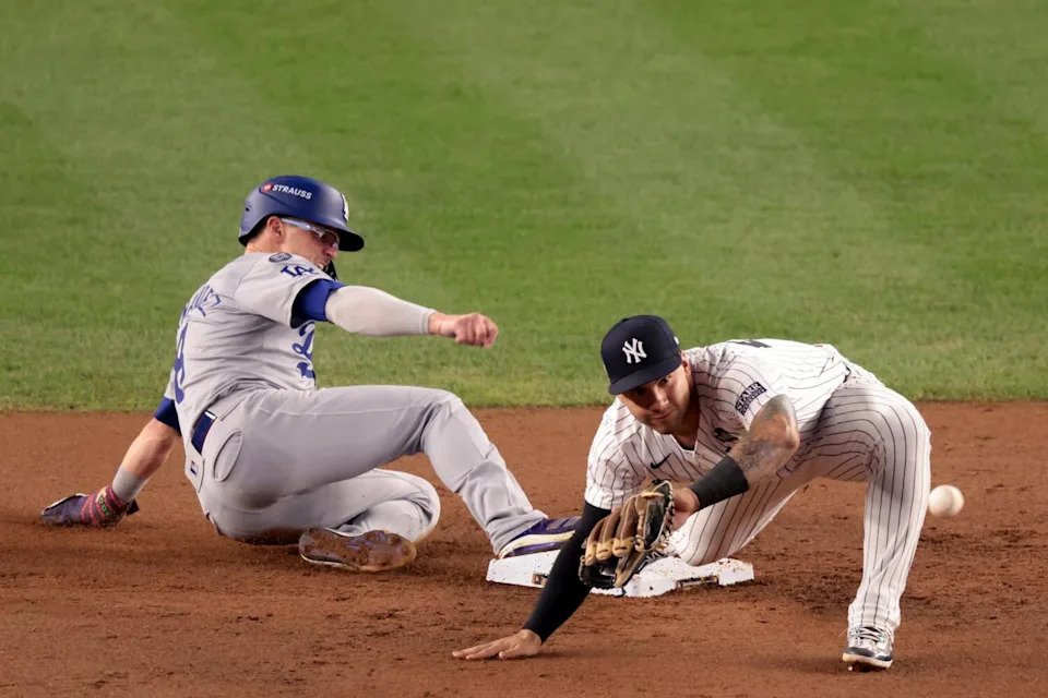 Dodgers third base Kiké Hernández is safe at second base after an error by Yankees outfielder Aaron Judge