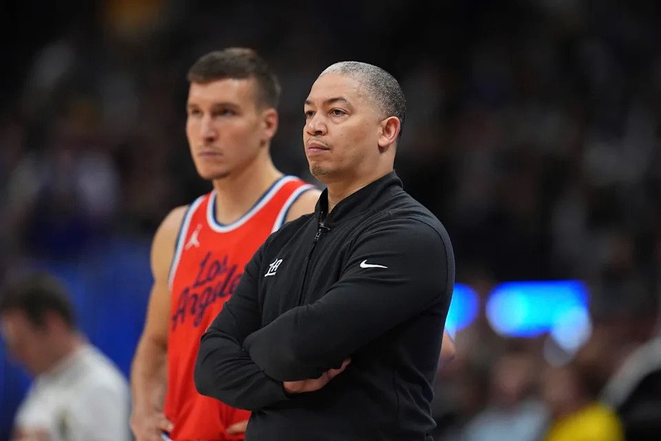 Clippers coach Tyronn Lue, right, looks on with guard Bogdan Bogdanovic, left, during the second half.