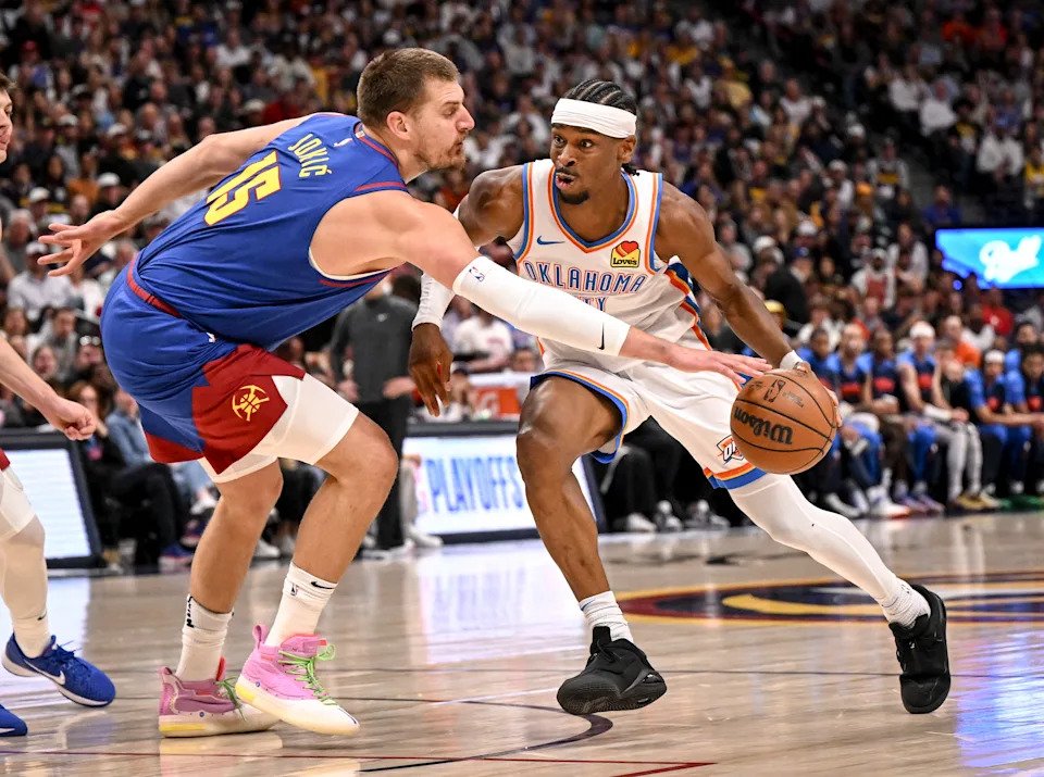 DENVER, CO - MAY 9: Nikola Jokic (15) of the Denver Nuggets pokes the ball away from Shai Gilgeous-Alexander (2) of the Oklahoma City Thunder during the first quarter at Ball Arena in Denver, Colorado on Friday, May 9, 2025. (Photo by AAron Ontiveroz/The Denver Post)