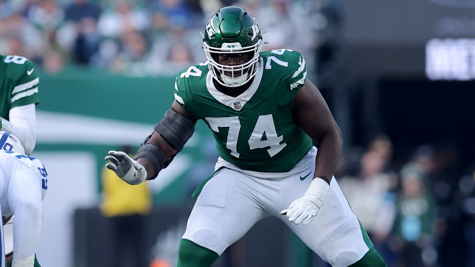 New York Jets offensive tackle Olu Fashanu (74) blocks for quarterback Aaron Rodgers (8) during the second quarter against the Indianapolis Colts at MetLife Stadium