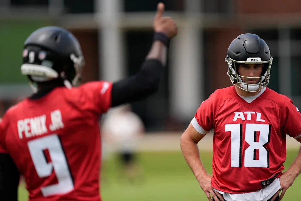 Kirk Cousins, right, remains a high-priced back up to Michael Penix Jr. (AP Photo/Mike Stewart)