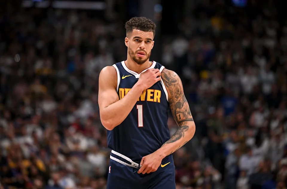 DENVER, CO - APRIL 21: Michael Porter Jr. (1) of the Denver Nuggets holds his shoulder after a scramble for a loose ball against Kris Dunn (8) of the LA Clippers ended up on the ground during the fourth quarter of the Clippers' 105-102 win at Ball Arena in Denver, Colorado on Monday, April 21, 2025. (Photo by AAron Ontiveroz/The Denver Post)