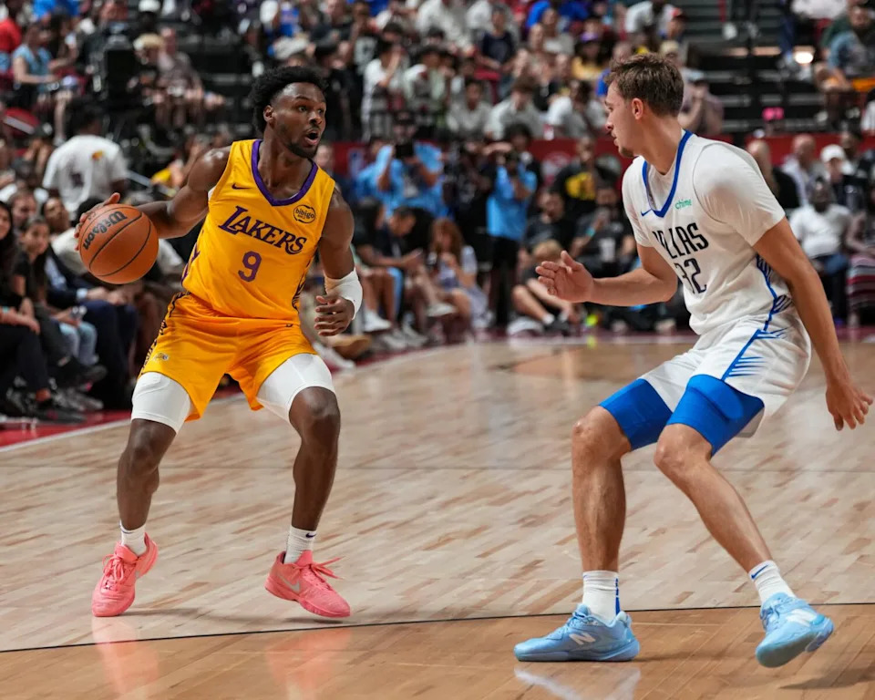 Lakers guard Bronny James, left, controls the ball in front of Dallas Mavericks forward Cooper Flagg.