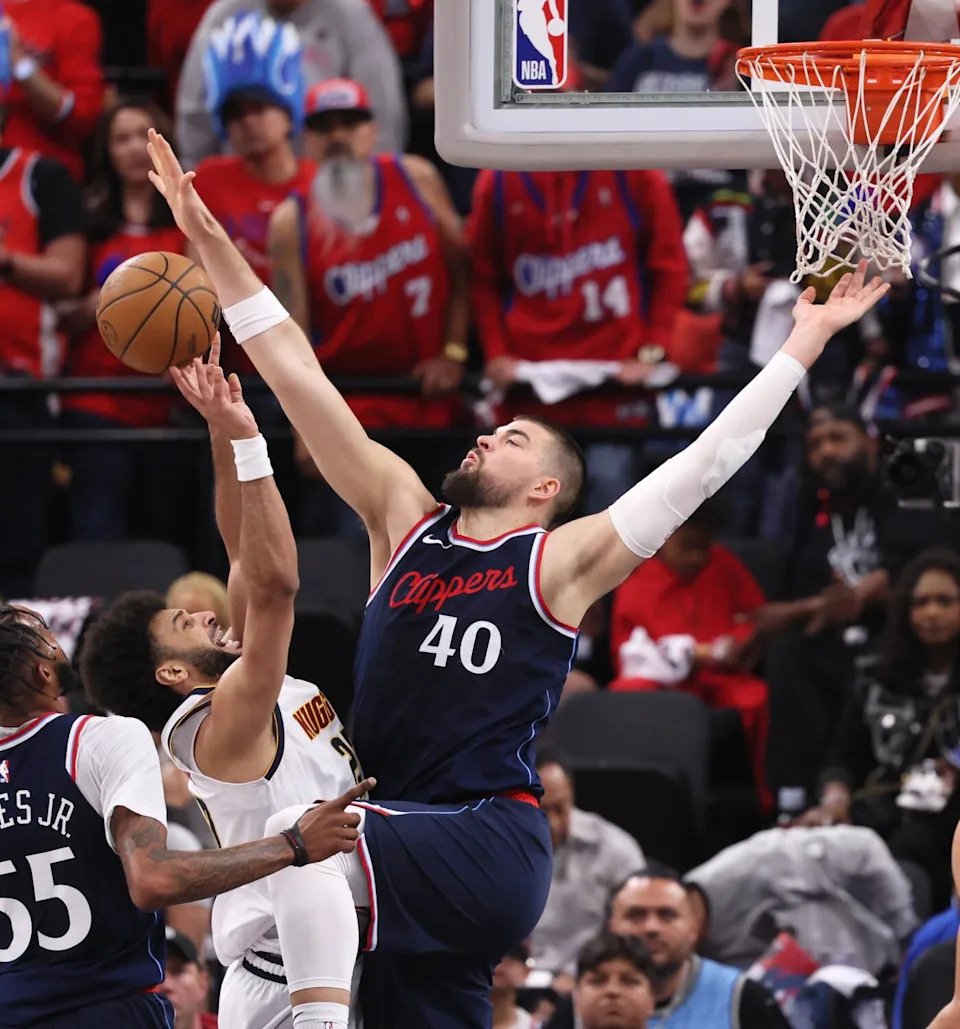 Clippers center Ivica Zubac, right, blocks a shot by Denver Nuggets guard Jamal Murray.