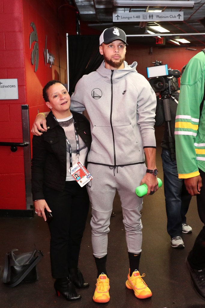 Golden State Warriors Stephen Curry with his right arm around Chrysa Chin.