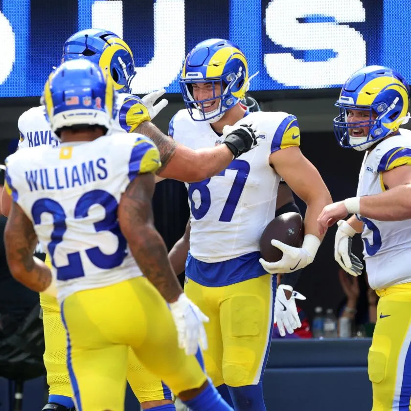 Rams tight end Davis Allen (87) celebrates with teammates after making a touchdown catch.