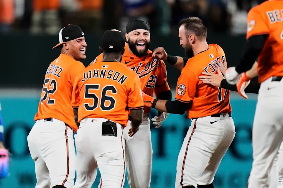 Baltimore's Emmanuel Rivera, third from left, celebrates with teammates after hitting a walk-off single.