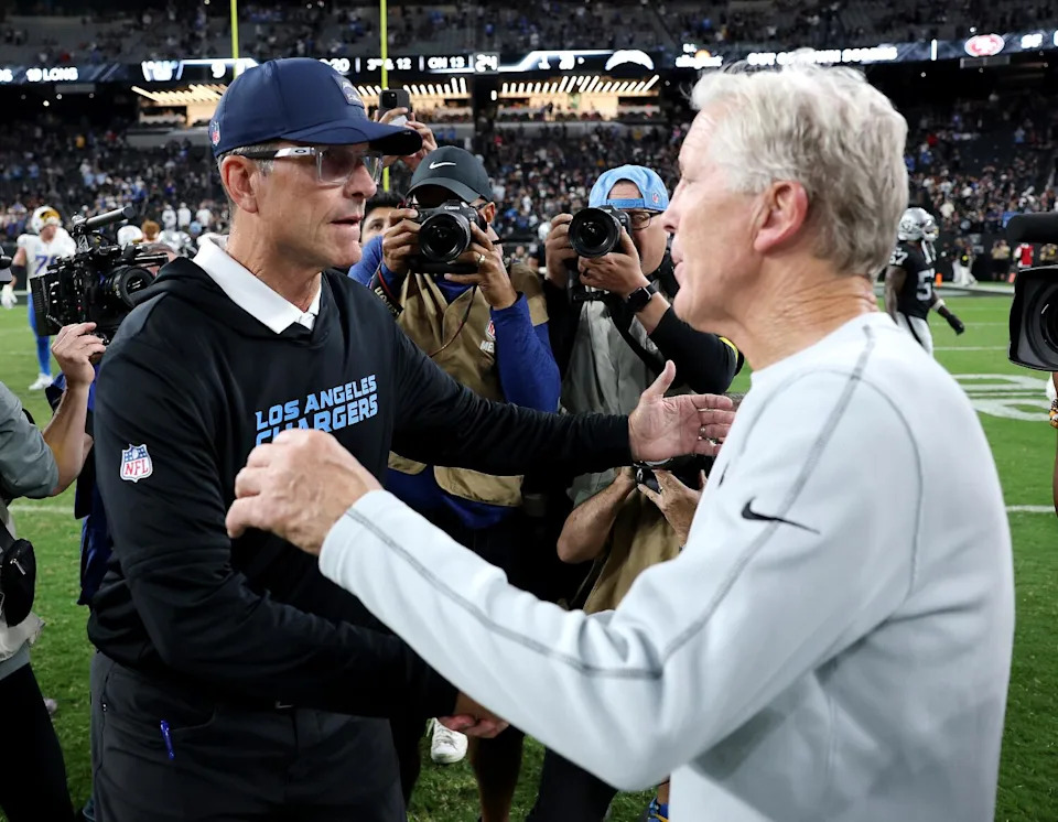 Chargers coach Jim Harbaugh and Raiders coach Pete Carroll shake hands after the Chargers' win Monday.