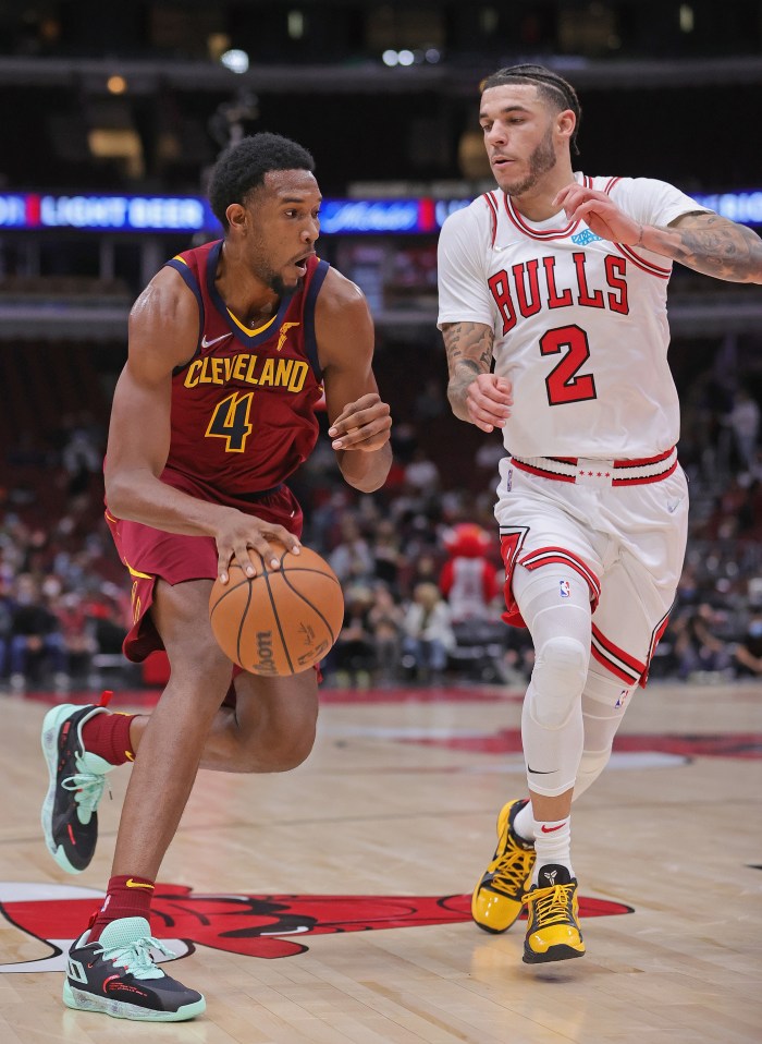 Evan Mobley drives to the basket against Lonzo Ball of the Chicago Bulls during a preseason game.
