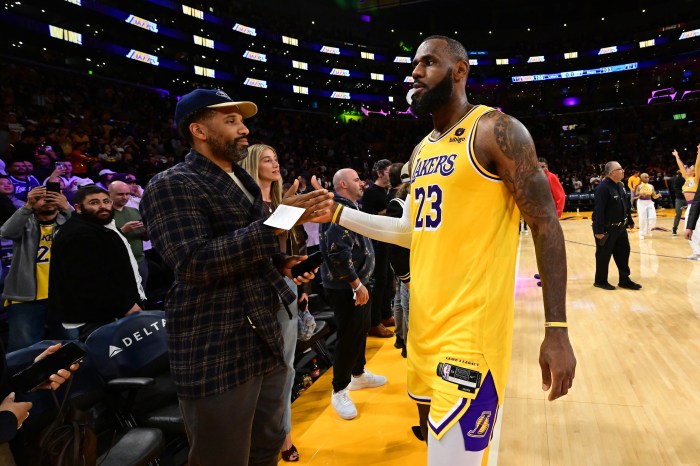 Maverick Carter high-fives LeBron James after a game.