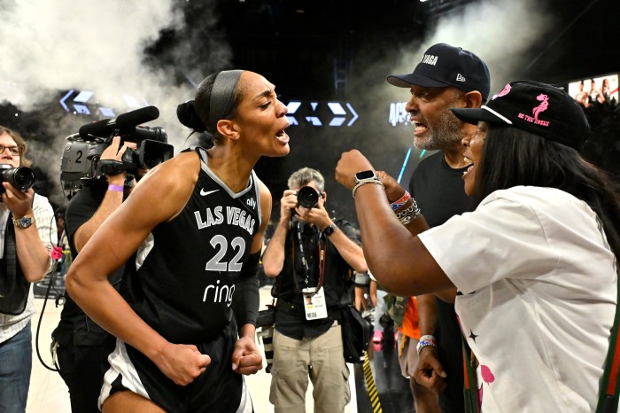 Las Vegas Aces forward A'ja Wilson (left) celebrates with her parents Roscoe Wilson Jr. and Eva Wilson after winning the game against the Seattle Storm during Game 3 of their first-round series on Sept. 18 at Michelob ULTRA Arena in Las Vegas.