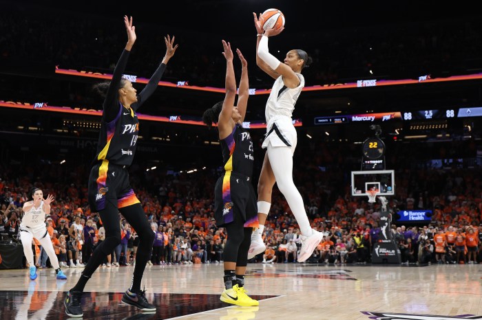 Las Vegas Aces forward A'ja Wilson (right) makes the go-ahead basket against the Phoenix Mercury with less than one second left in the fourth quarter of Game 3 of the 2025 WNBA Finals at Mortgage Matchup Center on Oct. 8 in Phoenix.