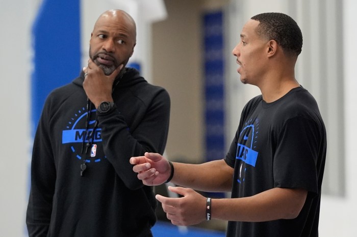 Orlando Magic head coach Jamahl Mosley, left, talks with guard Desmond Bane during the NBA basketball team's practice