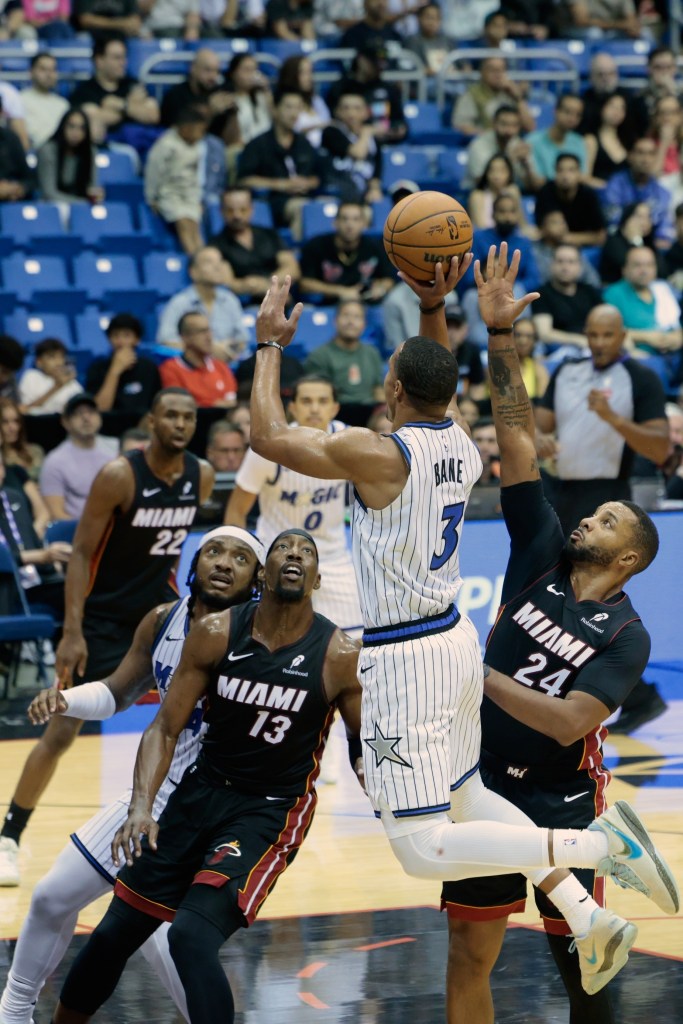 Desmond Bane shoots the ball over Bam Adebayo and Norman Powell